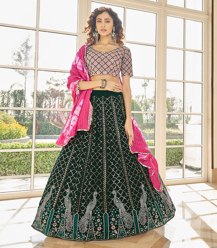 Photo of pastel pink bridal lehenga with unique blouse and green jewellery